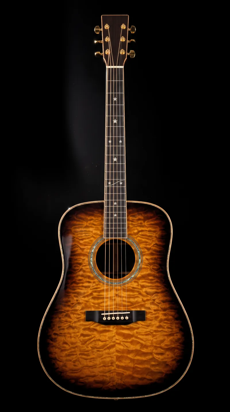 A quilted-maple dreadnought guitar in a whisky-coloured burst, standing upright against pure black under one hard light from the upper left, with pearl stars inlaid down its dark fingerboard.