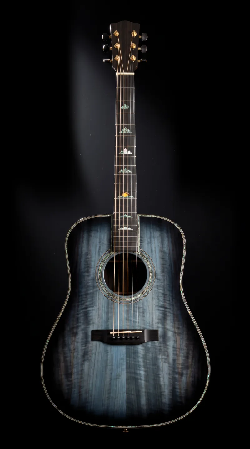 A figured black-walnut dreadnought under a smoke-blue burst, standing upright against pure black under one hard light, an abalone mountain road and ridgelines winding up its fingerboard to a rising sun at the twelfth fret.